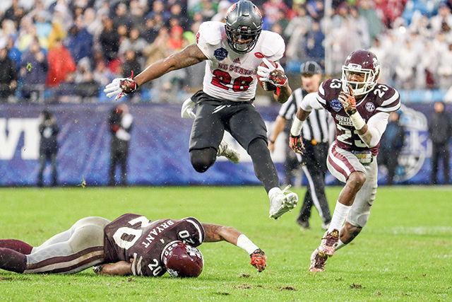 Sophomore tight end/full back Jaylen Samuels hurdles a defender on the way to a 48-yard touchdown. Samuels had 53 yards rushing on three carries in the game. The Wolfpack lost to the Mississippi State Bulldogs in the Belk Bowl 51-28 at Bank of America Stadium Dec. 30.