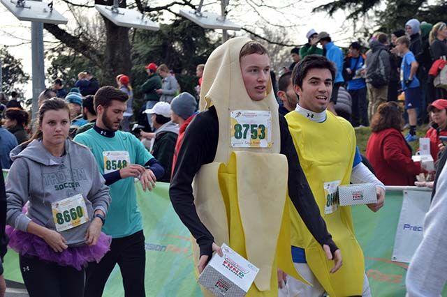 Brian Moloney and Jaime Riego, exchange students dressed as bananas, finish the race with their doughnuts in hand. "This is what we wore tailgating at all the football games last semester so we thought we'd keep it up," said Moloney. This was their first time running the race.