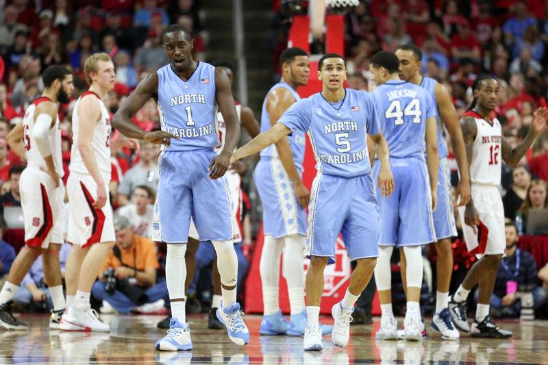 Marcus Paige taps Theo Pinson on the back after a play. The NC State Wolfpack lost to the UNC tarheels, 80-68, at PNC Arena on February 24, 2016.