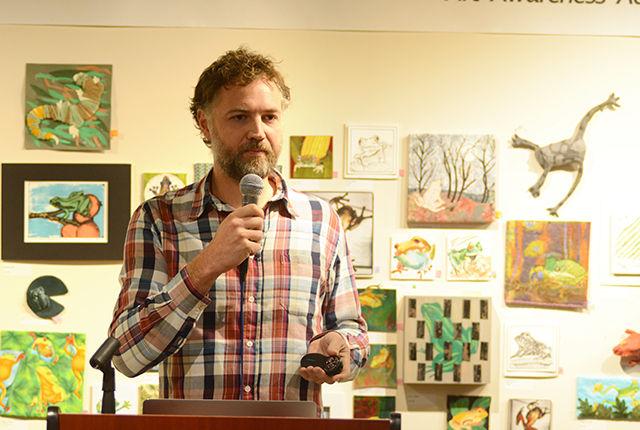 Robin Moore speaking on his project titled "Disappearing Frogs" on Thursday, Feb. 25 2016 in the Crafts Center located in Thompson Hall. His project features photos of endangered species of frogs from Cenral America and all over the World that him and his colleagues are working to conserve.
