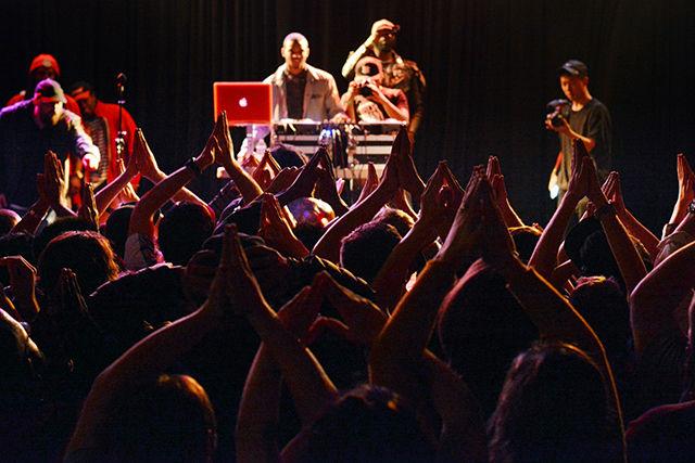 Charlotte-based rapper Deniro Farrar poses himself and concert attendees for a photo during the second night of WKNC's 13th Double Barrel Benefit held Saturday night at Cat's Cradle. He ended his performance by jumping into the crowd and giving hugs to everyone he could.