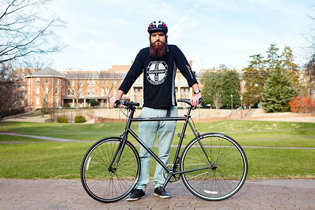 Brian Iezzi, a senior studying textile engineering, stands with a bike that can be checked out through the Quad Bikes bike share program.&#160; Iezzi is the co-founder of the Quad Bikes bike share program as well as the co-founder of Platinix, a startup that provides a replacement for platinum in the synthesis of hydrogen gas.
