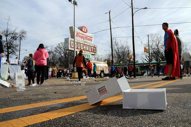 An empty box of doughnuts lies in the street after participants begin the run back to the belltower and volunteers for the Krispy Kreme Challenge begin cleaning up on February 6, 2016. The event totaled 7,000 registerd participants and raised $195,000 for the UNC Children's Hospital.