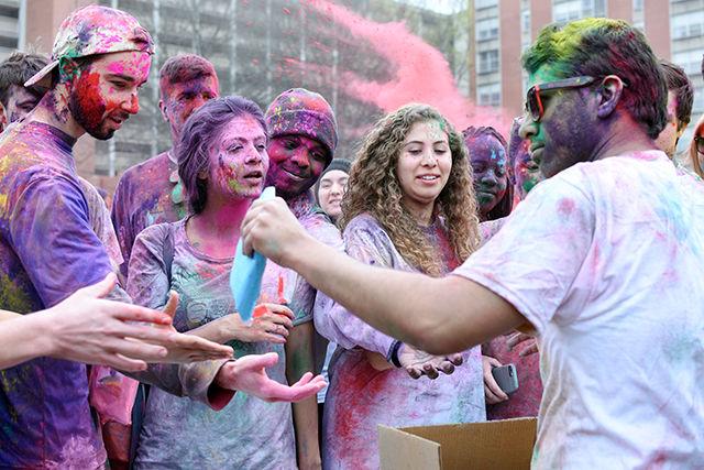 Members of Ektaa, a south Asian student group on campus, hand out packets of colored powder for Holi, an Indian festival filled with colors. This event was cohosted by Maitri, Ektaa, and Kappa Phi Lambda and took place on March 19, 2016 on Lee Field.