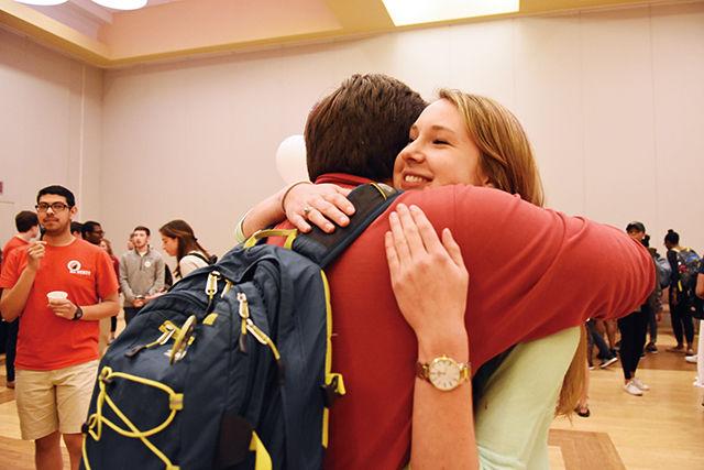 Cody Long, a junior studying political science, hugs Amanda Cannon, a senior studying business administration, after the announcing of the election results on Tuesday.