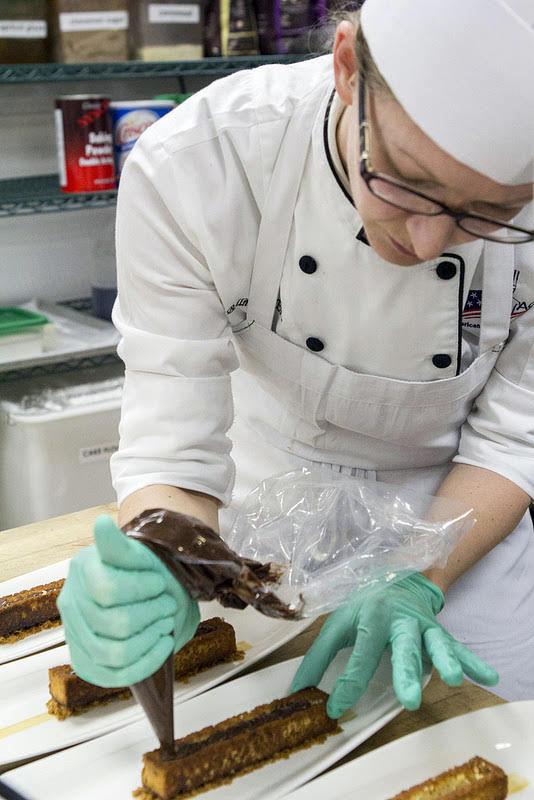 Kelly Bellmore prepares a banana chiffon with milk chocolate ganache,&#160;for the 2016 American Culinary Federation Southeast Region Pastry Chef of the Year competition in Atlanta, Georgia. She went on to win the competition, qualifying her for the National competition.