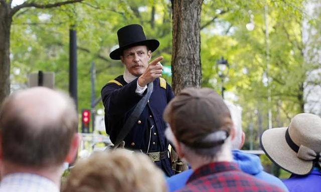 Ernest Dollar serves as the director of the City of Raleigh Museum. He appears here in historic garb while giving a tour in downtown Raleigh.