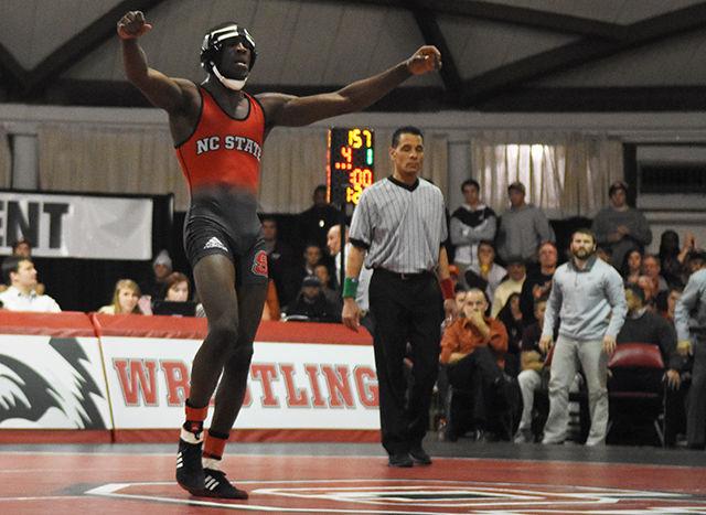 Starting 157 pounder, redshirt senior Tommy Gantt raises his hand in victory after beating his opponent during the meet against Virginia Tech. Despite his victory, the Wolfpack would go on to lose the match to the Hokies. This dual meet was held in the Holshouser Building on Friday, Feb 12, 2016.