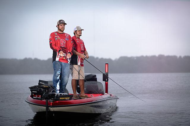 Two members of the NC State club bass fishing team cast their lines into the water hoping to get a bite.&#160;
