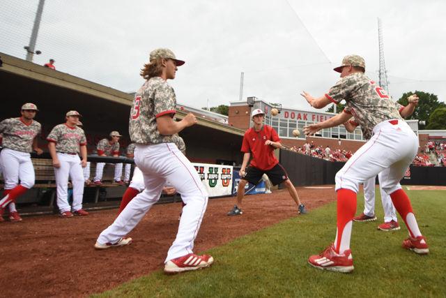 Wolfpack players play a game with 6 baseballs where they see how long they can toss them back and forth before someone drops a ball before the Wolfpack's fifth game of the NCAA Raleigh Regional against Coastal Carolina at Doak Field on June 6, 2016.