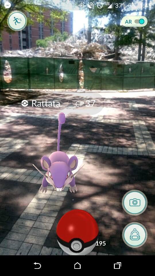 Erin McDermott, a research technician in entomology and plant pathology, captures a Rattata in front of the remnants of Harrelson Hall.&#160;