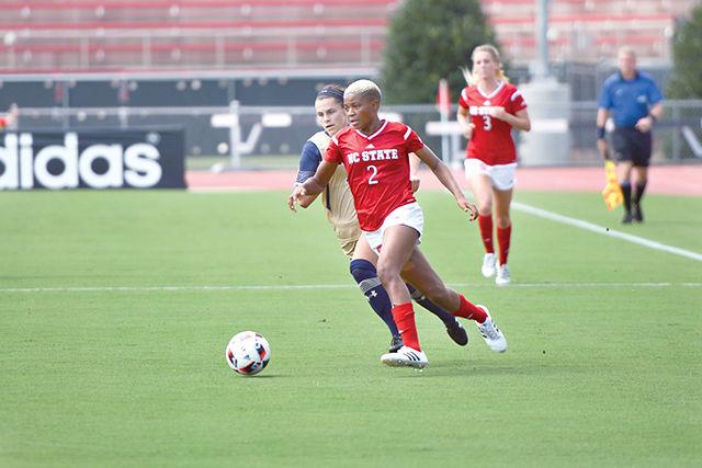 Freshman midfielder Tziarra King dribbles the ball, sprinting ahead of a Navy forward. The NC State women's soccer team beat Navy 4-1 at Dail Soccer Stadium on Sunday.