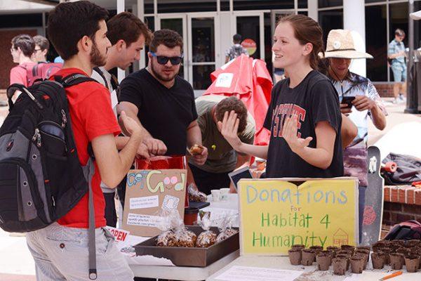Alex Hornaday, a freshman studying environmental sciences , talks with Eleanor Williams, a senior studying human biology,
over succulents and snacks in the Brickyard Wednesday. The succulents and granola being offered to students were brought
to NC State by The Good Club, a “student community focused on spreading health and happiness on campus.” Students were asked to donate money in order to take a succulent or bag of granola home, and all the proceeds from the event will go the Habitat for Humanity, and also to help out the NC State Cypher, which happens right outside the Free Expression Tunnel every Monday at 9 p.m. The Good Club will be hosting the event “Succulents and Snacks” again next week on Tuesday in the same location. 