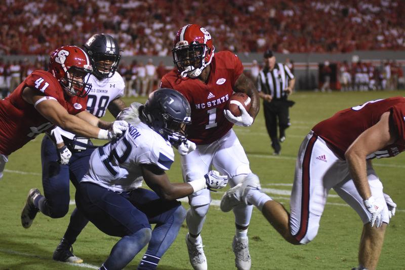 Senior tight end, Clark Eyers, blocks for junior tight end and fullback, Jaylen Samuels, as he runs the ball at the Old Dominion game held at Carter Finley Stadium on Saturday night, Sept. 17. Samuels ran a total of 22 yards at the game against Old Dominion.