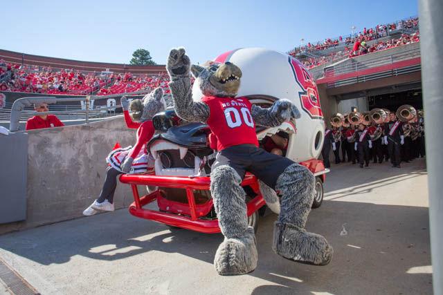 Mr. and Ms. Wuf ride on to the field on the helmet car before the 33-16 win over the Demon Deacons on Oct. 1st in Carter-Finley Stadium.