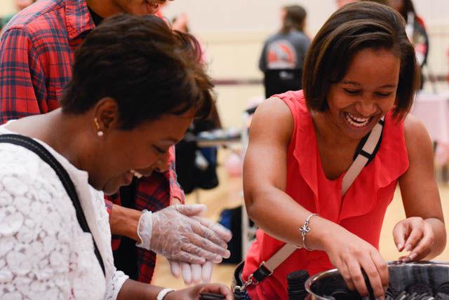 Doriane Taylor, a senior studying chemistry, competes in an Oreo stacking competition with her mother Valencia at the Chocolate Festival in the State Ballroom at Talley Student Union on Sept. 30. Competitors had 20 seconds to stack as many Oreos as they could without falling. The competition was hosted by Inter-Residence Council and the National Society for Residence Halls.