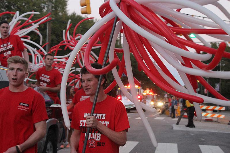 Members of the Student Wolfpack Club wave balloons as a part of their float in the homecoming parade on Friday. The annual parade ran down Hillsborough Street and featured face-painters, musicians, jugglers and more.
&#160;