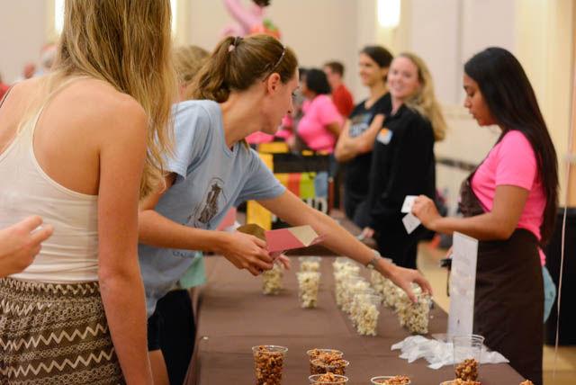 Chocolate Festival attendees pick up chocolate popcorn treats from the Carolina Popcorn Shoppe in the State Ballroom on Sept. 30. Donations from the Chocolate Festival go to the Kay Yow Cancer Fund. The Chocolate Festival is in its 13th year being held at NC State.