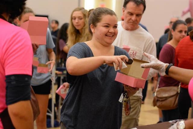 Sarah Baur, a junior studying accounting, receives a treat from a volunteer at the Chocolate Festival in the State Ballroom of Talley Student Union on Sept. 30. Proceeds from the event go to the Kay Yow Cancer Foundation.