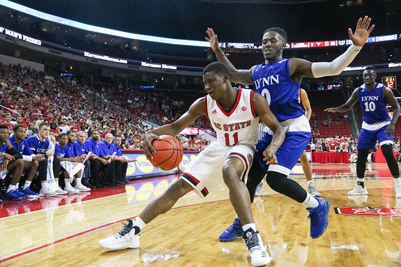 Freshman guard Markell Johnson shields the ball from a Lynn Univserity player. Johnson took four shots during the game and made three. NC State beat Lynn University 100-66 on Thursday at PNC Arena.