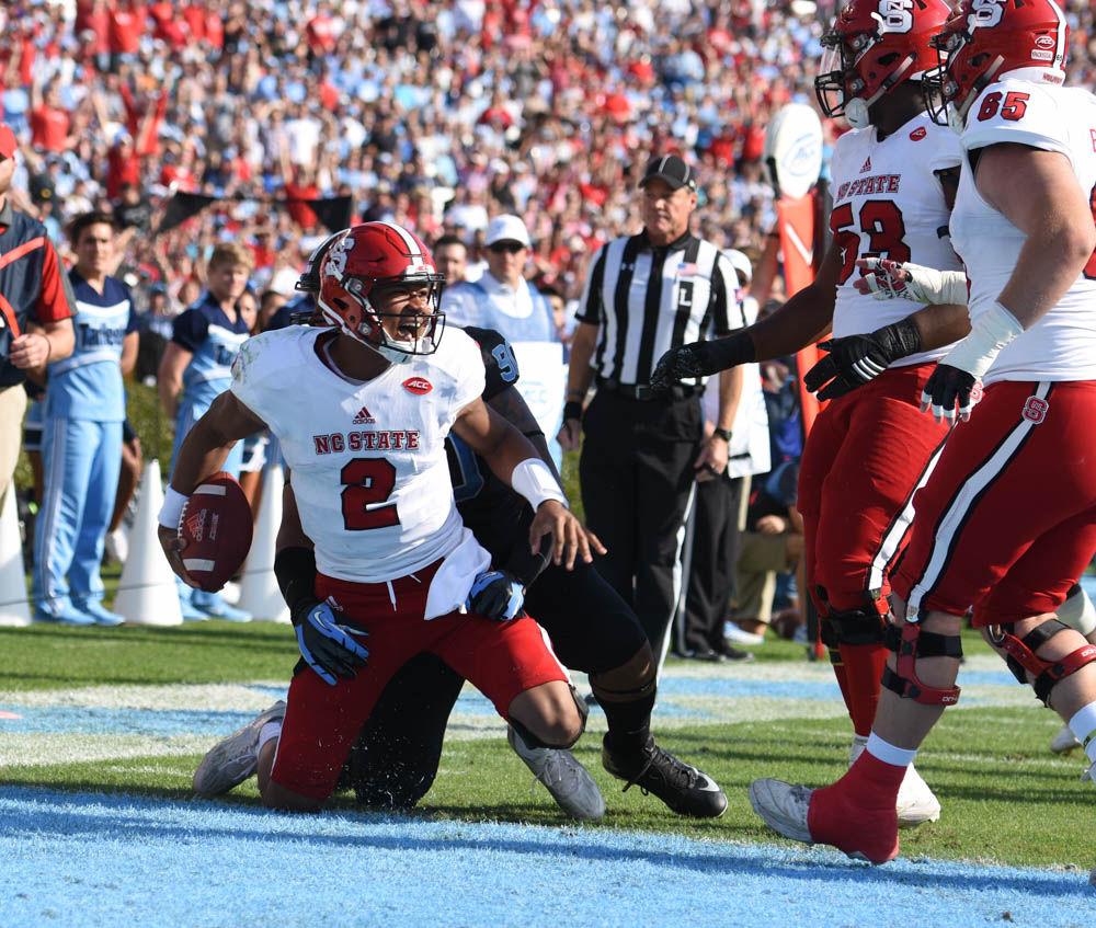 Sophomore quarterback Jalan McClendon celebrates in Kenan Stadium on Friday after making a gain for the Wolfpack. McClendon had 23 passing yards in the game. NC State defeated UNC, 28-21.