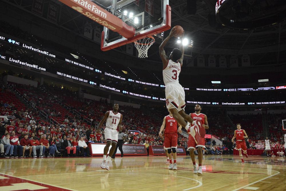 Redshirt Senior Terry Henderson goes up for a dunk over players from Boston University. Henderson lead the Men's Basketball team with a total of 23 points. The Wolfpack had a close win over Boston University with a final score of 77-73.