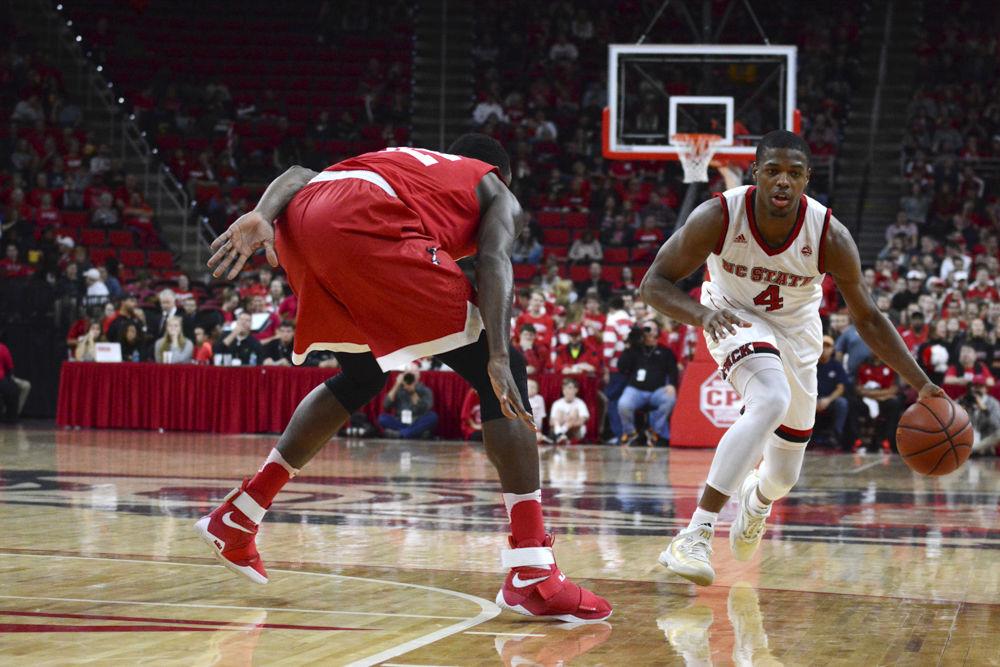 Freshman Dennis Smith Jr. down court against a player from Boston University. The freshman starter played hard offensively in the game against Boston University in PNC Arena on Saturday.
