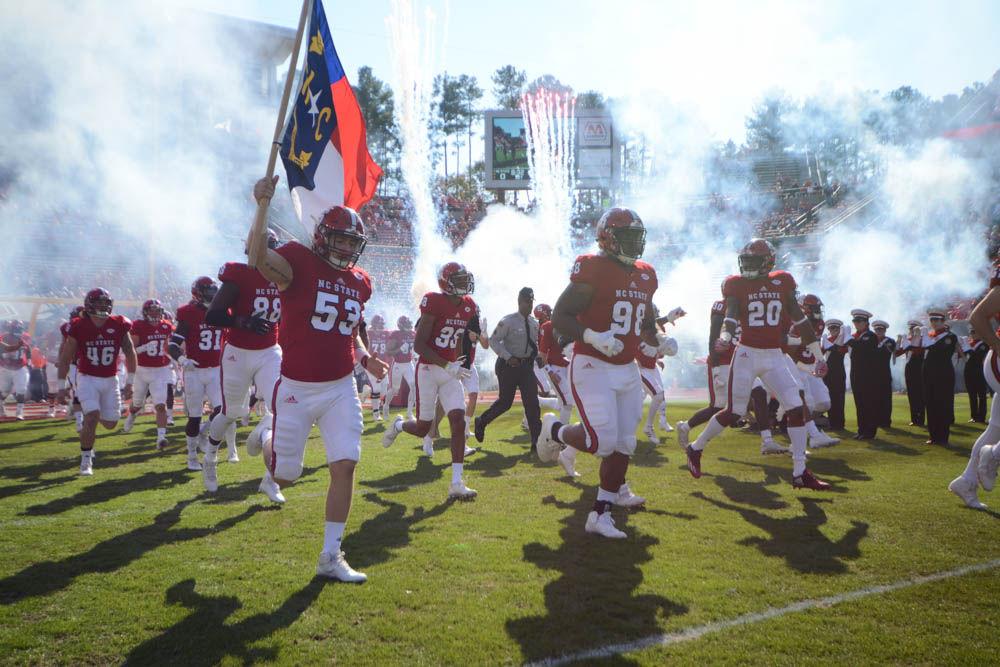 Memebrs of the Wolfpack storm the field prior to the game against the University of Miami on Saturday. The Wolfpack lost to the Miami Hurricanes in the final home game of the season, 27-13.
