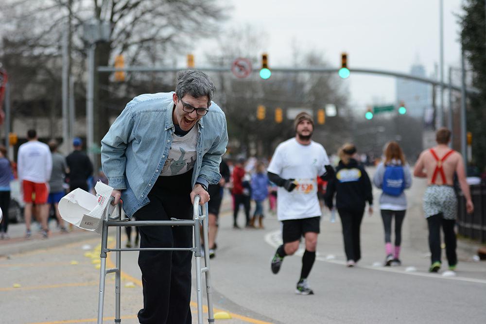 Matthew Powell leans forward while laughing at one of his friends. Powell and his friends dressed up as old people and provided a source of entertainment for the runners and spectators at the Krispy Kreme Challenge near the Belltower. The event consisted of approximately 7,700 racers and raised $200,000 for the UNC Children's Hospital on Saturday, Feb. 8, 2014.