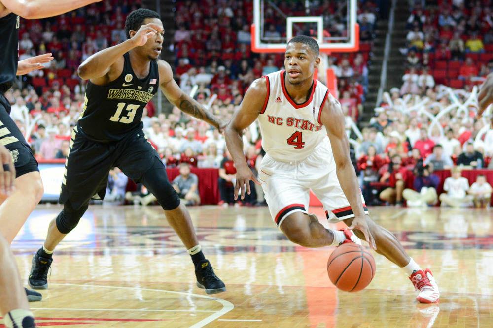 Freshman guard Dennis Smith Jr. dribbles the ball around a Wake Forest player towards the goal. Smith did well with his free throws during the game scoring 9 of 11. NC State lost to Wake Forest 88-93 at PNC Arena on Jan. 21.