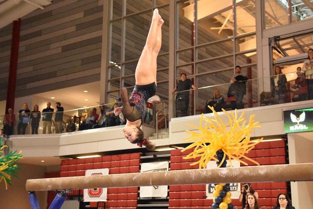 Alexa Phillips, a sophomore, spots her landing as she dismounts from the beam during the 2017 EAGL gymnastics championship in Reynolds Coliseum on March 18. Phillips scored in the top five of the all-around scores to help pull the pack into third place.