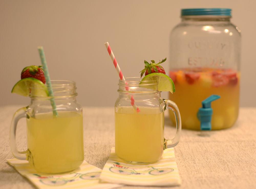 Tropical sangria is an easy cocktail for a hot summer day. Garnish with lime slices and fresh strawberries for your next picnic or party. For a non-alcoholic version, substitute champagne and rum with soda water and fruit juice.