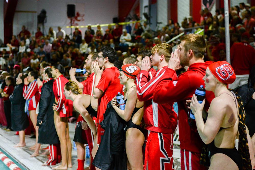 Swimmers from the men's and women;s teams cheer on their team mates from the side of the pool. NC State beat Carolina in 26 of 32 events at Willis R. Casey Aquatic Center on Jan. 27.