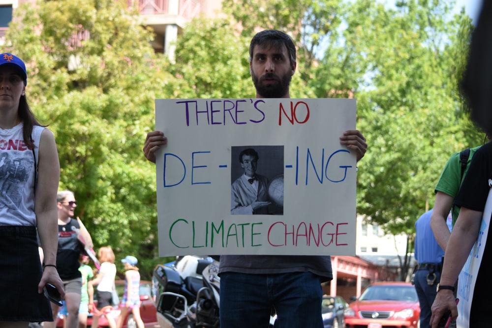 A man holds a sign that reads "There's no de-Nye-ing climate change" at the Raleigh March for Science, Saturday, April 22, 2017. Scientists, science enthusiasts, and concerned citizens came together as the first step of a global movement to defend the role of science in health, safety, economies, and governments. 610 satellite marches gathered around the world to acknowledge and voice the critical role of science in everyone's lives. The Raleigh March for Science began at Shaw University and ended on Moore Square.