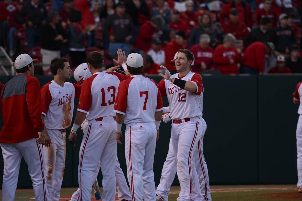Freshmen center Brad Debo high-fives his teammates after scoring against Florida State on April 8, 2017. Dabo had 1 run at four at bats. The Wolfpack beat #22 FSU 8-4 at Doak Field.