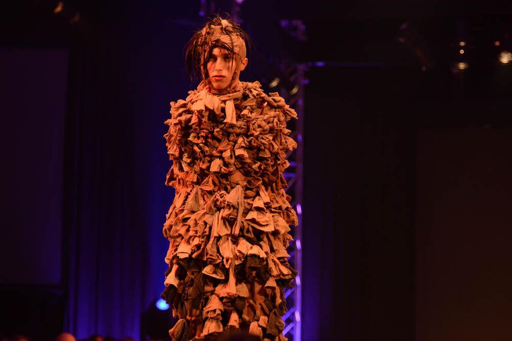 A model strikes a pose on the runway dressed in designs made by Jeanna Young, a senior studying art and design, as part of her collection Delusions of Identity. Art 2 Wear, a fashion show planned and executed by students in the College of Design, took place at Talley Student Union on April 28, 2017.