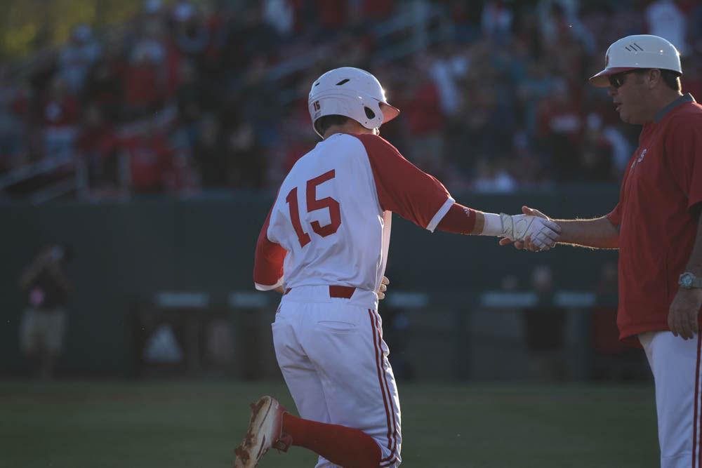 Junior centerfield Josh McLain shakes the coach's hand as he walks off the field from a homerun on April 8, 2017 in the Wolfpack's game against Florida State University. McLain had 1 run and two hits in five at bats in the 8-4 win at Doak Field.