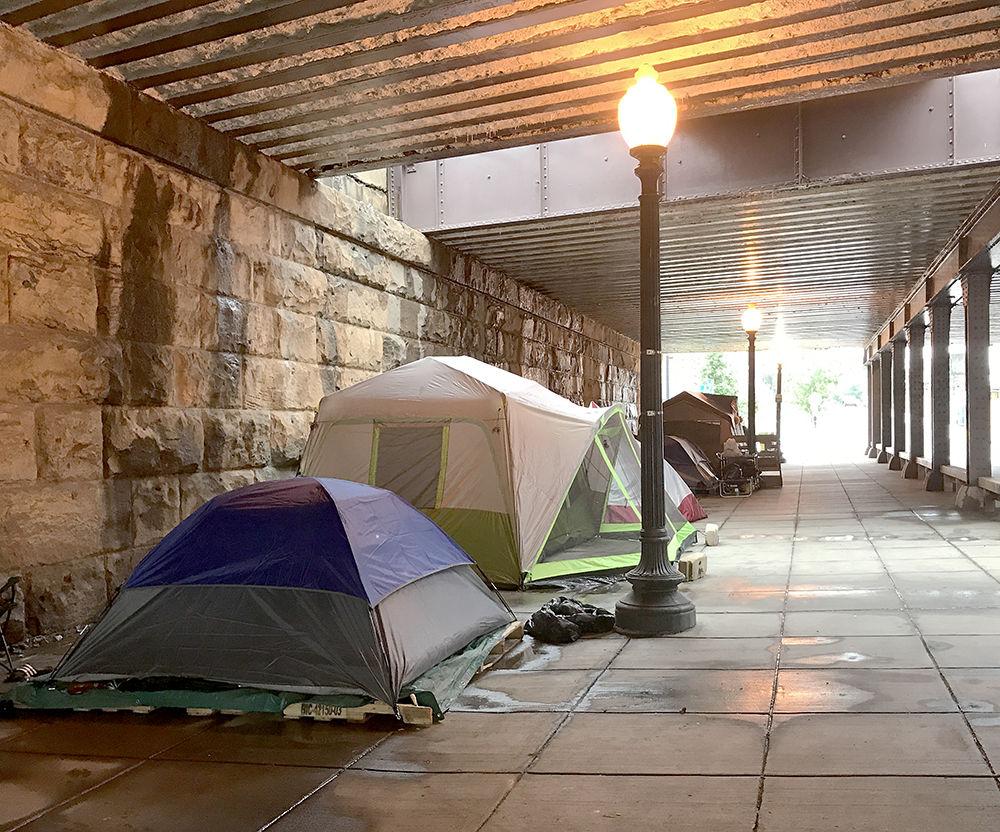 Homeless individuals spend their days in tents under a bridge along 158-166 L St. in Washington, D.C.
