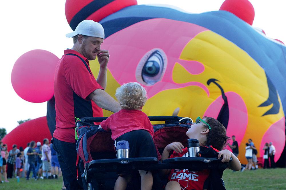 Finley, 3, and Blake, 5, turn to look at the more than 30 hot air balloons at the WRAL Freedom Balloon Festival on May 27, 2017. Their father, Phillip Boyd is an NC State alumnus from the class of 2001, and Finley is named after Carter-Finley Stadium.