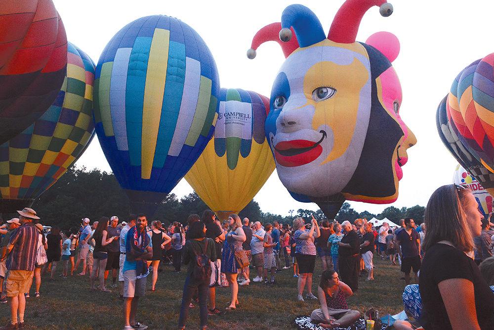 Hundreds of people gather in Fuquay-Varina to admire the hot air balloons at the WRAL Freedom Balloon Festival on May 27, 2017. The event featured more than 30 hot air balloons, food and beer vendors and live music performances.