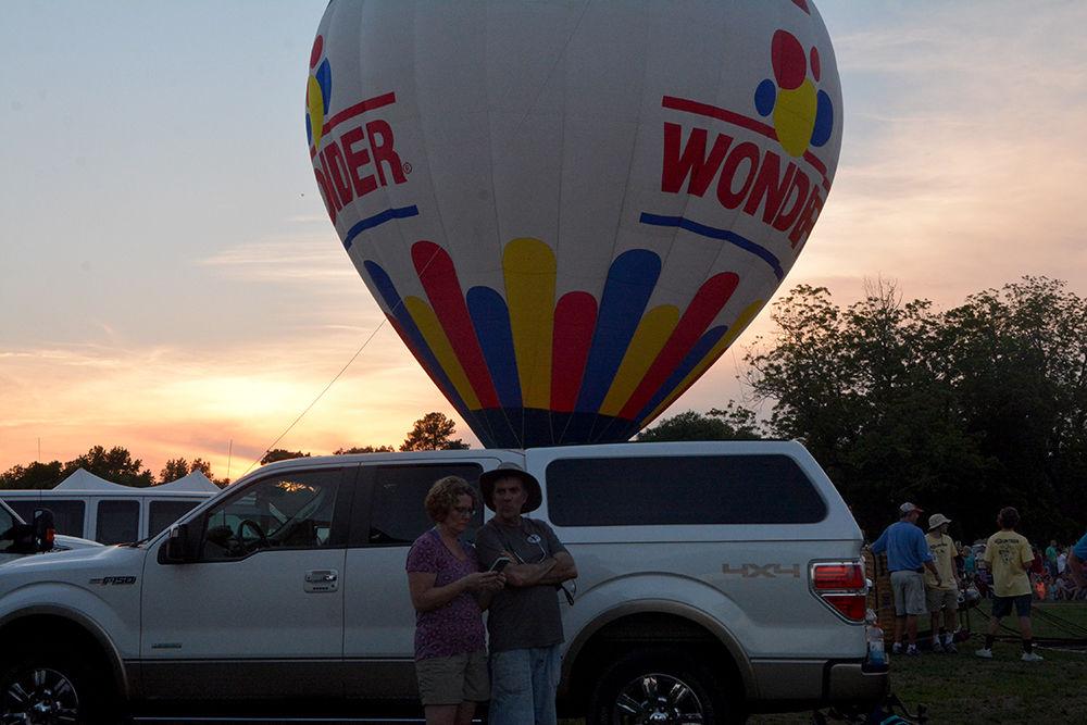 A couple stands in front of the Wonder bread hot air balloon at the WRAL Freedom Balloon Festival on May 27, 2017 in Fuquay-Varina. This balloon was one of the more than 30 hot air balloons at the festival, which also featured food and beer vendors and live music performances.