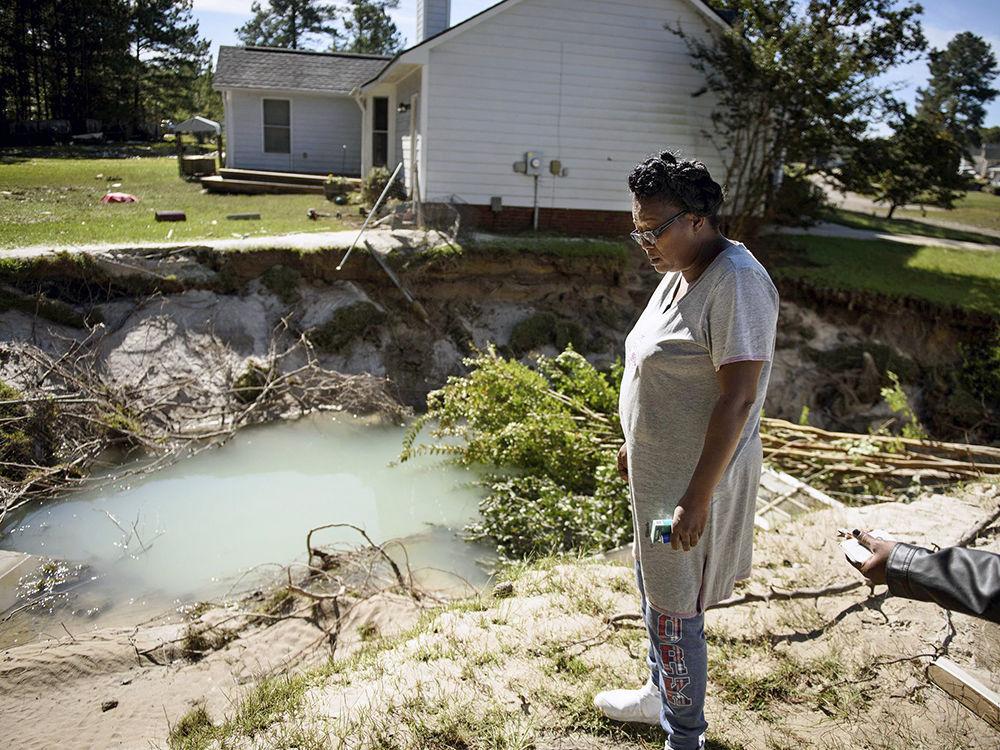 Evelyn McCormick looks out at what used to be her back yard in Hope Mills, NC.