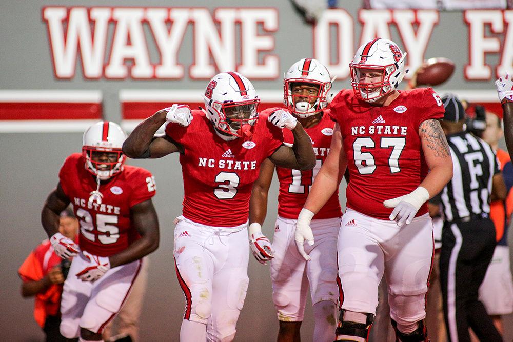 Sophomore wide receiver Kelvin Harmon flexes after dragging two defenders into the end zone during the 37-20 win over Marshall University Saturday in Carter-Finley Stadium.