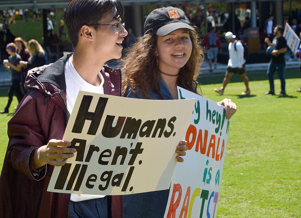 High school students David Warren and Risa Bolash, both juniors at Sanderson High School, participate during the DACA Rally at Stafford Commons on Friday. Many participants outside of NC State came to show their concerns regarding the planned ending of DACA.