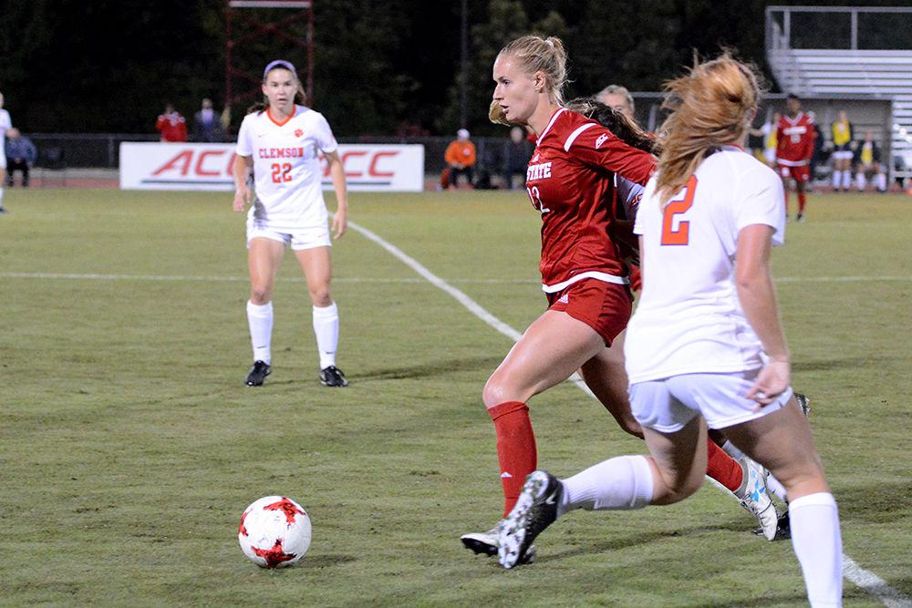 Senior midfielder Cailyn Boch carries the ball past a pair of Clemson defenders during the game. The Wolfpack would go on to win the game 1-0 in Dail Soccer Stadium on Thursday.