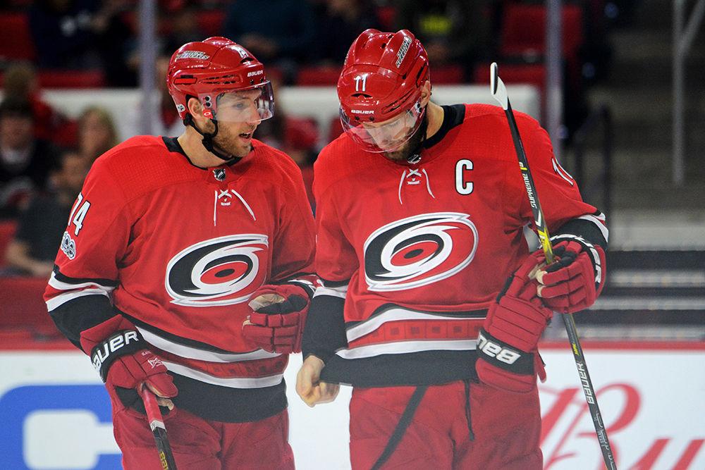 Defense Jacob Slavin and&#160;center&#160;Jordan Staal of the Carolina Hurricanes chat during a timeout at the game against Columbus Blue Jackets in PNC Arena on Tuesday Oct. 10. The Hurricanes lost to the Blue Jackets 2-1 in overtime.