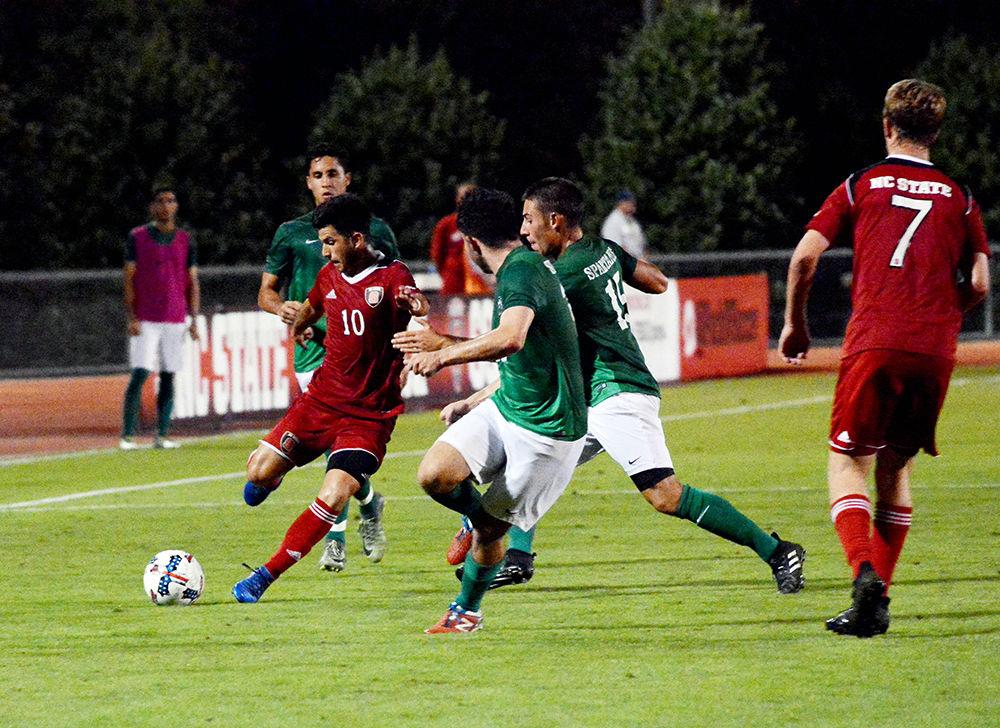 Freshman forward David Loera passes the ball during the Wolfpack's game against the USC Upstate Spartans on Tuesday in Dail Soccer Field. The Wolfpack tied with the Spartans 0-0 after two overtimes.