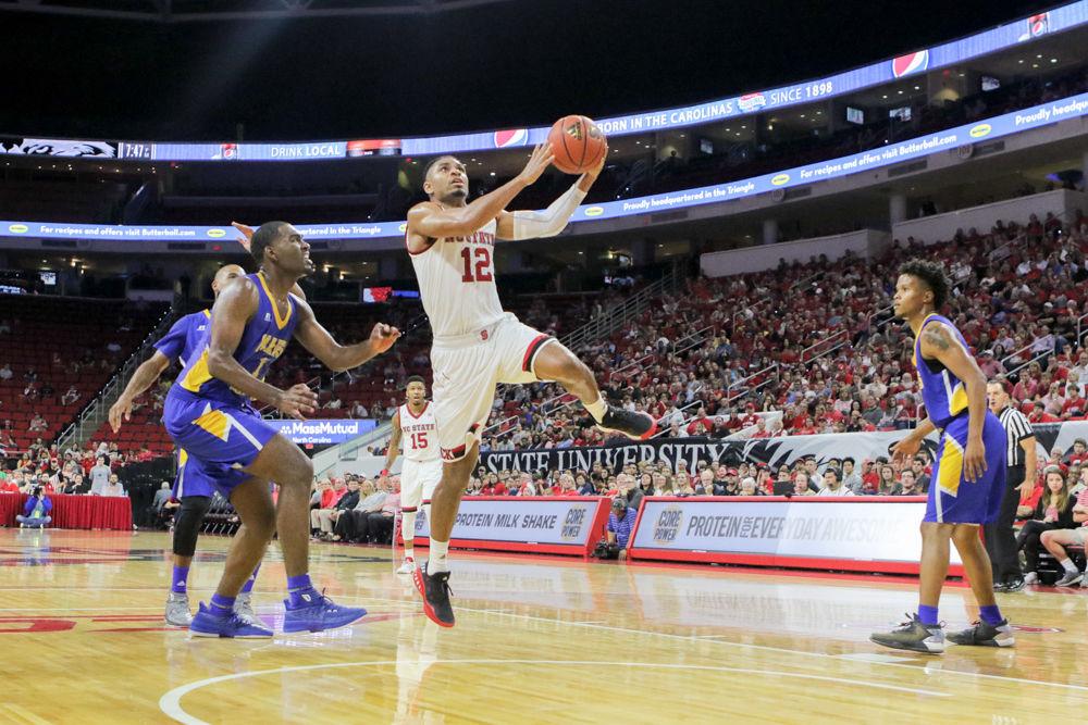 Graduate transfer guard Allerik Freeman breaks through the Mars Hill defense to go up for a quick layup. Freeman had 18 points to go along with eight boards. The Wolfpack showed off it's new defense and a high-powered offense with a 109-66 win over Mars Hill on Friday, Nov. 3 in PNC Arena.