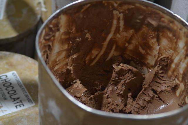 A vat of partially scooped chocolate ice cream sits in a refrigerator in the Howling Cow Ice Cream tent at the North Carolina State Fair on Oct 14. The tent sold their ice cream in either cups or cones for $5 each.