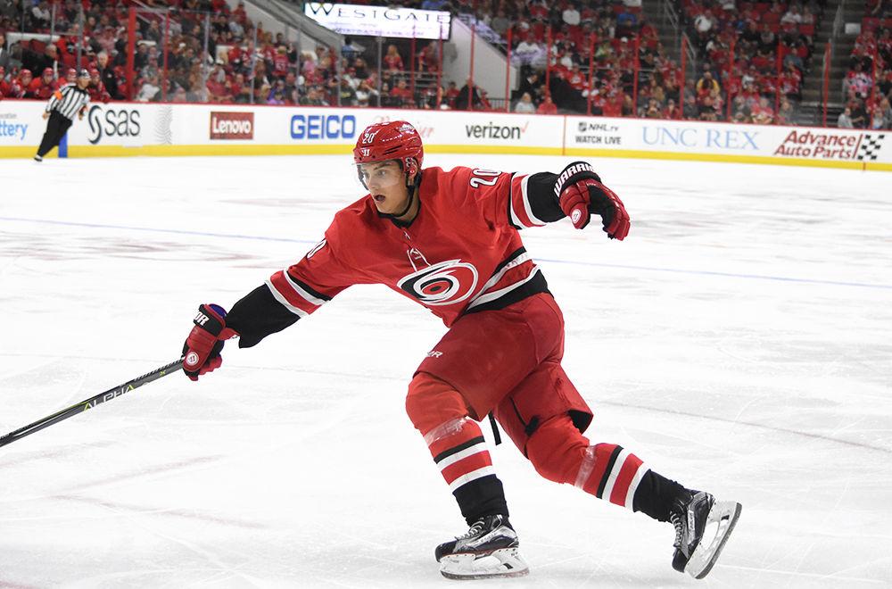 Sebastian Aho, left wing for Carolina Hurricanes, reaches for the puck during the game against Minnesota Wild in PNC Arena, Saturday, Oct. 7. Aho had 5 shots on goal and 2 assists. After overtime, the Carolina Hurricanes won in a shootout against the Minnesota Wild, 5-4.
